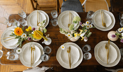 serving the table with fresh flowers and candles