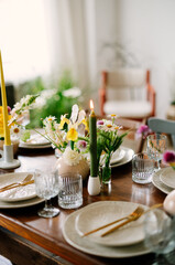 serving the table with fresh flowers and candles