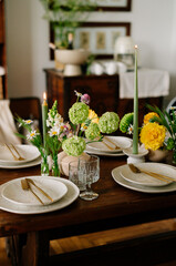 serving the table with fresh flowers and candles