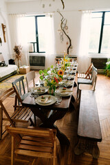 serving the table with fresh flowers and candles