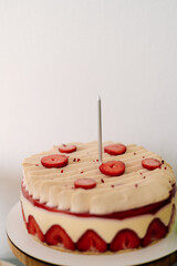white cake with strawberries on the table