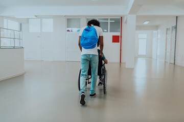 African American student pushing his friend's wheelchair through a modern school, demonstrating inclusion, accessibility, and the power of friendship.Assistance to people with disabilities