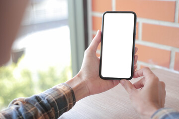 cell phone blank white screen mockup.hand holding texting using mobile on desk at office.background empty space for advertise.work people contact marketing business,technology