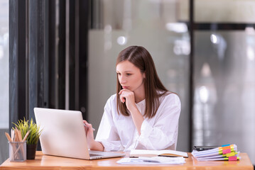 Businesswoman working in front of a laptop in the office.