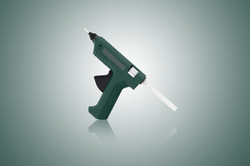 Glue gun on a white background. Electric glue gun close-up on a white background