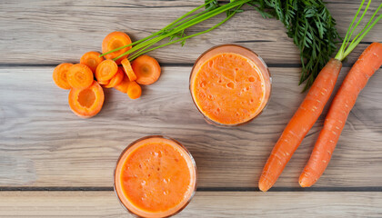 Carrot smoothies, and slices of carrots on a wooden table. The concept diet food for weight loss. Top view.