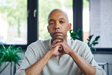Naklejka premium ptosis, eye syndrome, bold african american businessman looking at camera, dark skinned office worker with myasthenia gravis disease, diversity and inclusion, professional headshots
