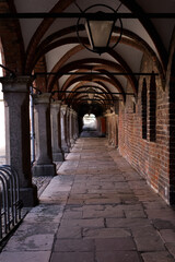 Fototapeta na wymiar Medieval empty corridor with arches in the old town
