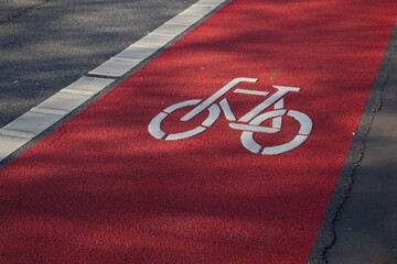 Red bicycle path on which a bicycle passes close-up 