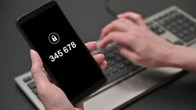 A woman's hand enters a one-time password for the verification process. Two factor authorization