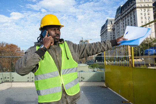 young black man construction company employee upset outdoors arguing on the phone