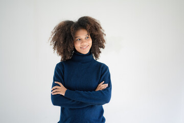 Young pretty African American woman standing and arms crossed over white background.