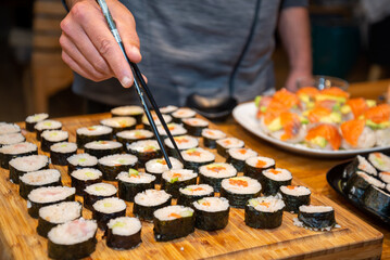 Overhead japanese sushi food. Maki ands rolls with tuna, salmon, shrimp, crab and avocado. Top view of assorted sushi.