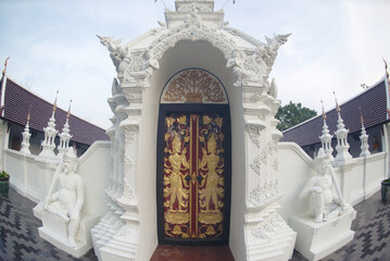 The entrance gate of Phra Chedi Chai Mongkhon Si Dvaravati with beautiful stucco and wooden...