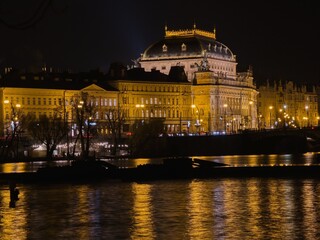 Prague at night. Residential buildings and the National Theater on the embankment of the Vltava River