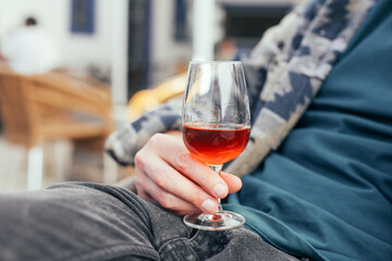 Man holding a glass of alcoholic beverage - Portuguese sweet wine Moscatel