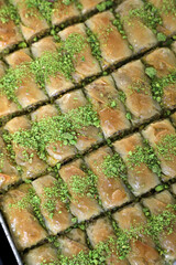 Traditional turkish dessert antep baklava with pistachio, ramadan or holiday desserts in tray, 
