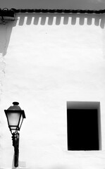 Whitewashed facade with vintage streetlight in Altea
