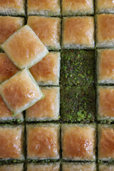 Traditional turkish dessert antep baklava with pistachio, ramadan or holiday desserts in tray, classic pistachio baklava
