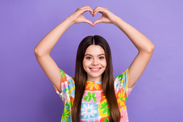 Fototapeta na wymiar Photo portrait of lovely teenager lady raise hands heart shape wear trendy flower print garment isolated on violet color background
