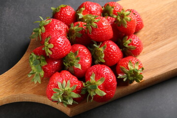 photo of a lot of strawberries lying on a wooden board