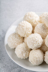 photo of round candies in coconut shavings on a plate
