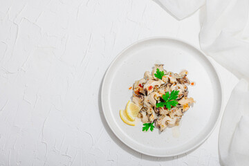 Rapana clam meat with oil, spices and greens. Healthy seafood is rich in omega. Marine decor