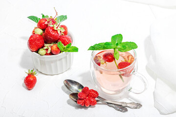 Strawberry tea concept. Good morning concept. Teapot, ripe fruits, healthy beverage