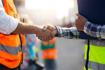 Handshake. Close up construction worker people shaking hands on business cooperation agreement....