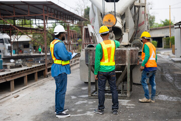 Mason construction worker working on site with Civil Engineer. Asian builders working pouring...