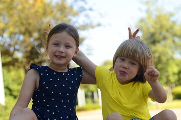 Brother and sister are preschoolers. Lovely children 4-5 years old. The older sister takes care of the younger one. Best friends. Children on a walk. First love, care, hugs