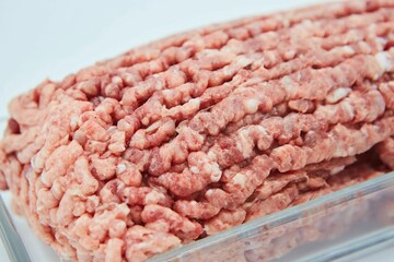 Raw meat ground into minced meat on a white background. Pork, beef or lamb. Different parts of meat products for different dishes.
