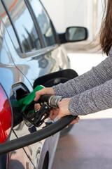 woman's hands refueling in the car