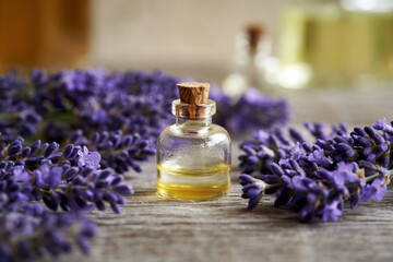 Obraz na płótnie Canvas A bottle of essential oil fresh blooming lavender flowers