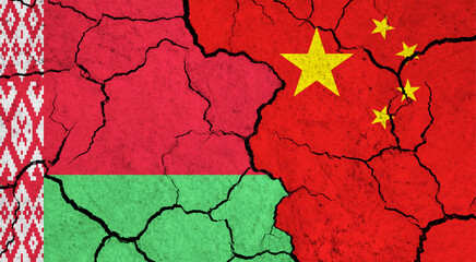 Flags of Belarus and China on cracked surface - politics, relationship concept