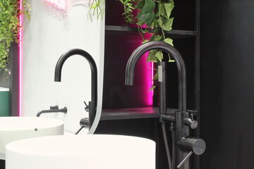 Nickel black bath shower mixer with white separate high vessel sink in expensive loft bathroom....