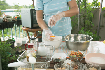 Female baker prepared dough balls and salted egg yolks for making mooncakes for traditional mid autumn festival