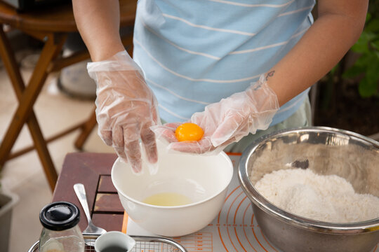 Female baker prepared dough balls and salted egg yolks for making mooncakes for traditional mid autumn festival