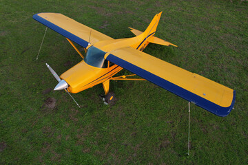 airplane carrying flying advertising banner parked on green grass