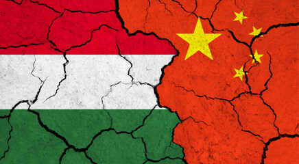 Flags of Hungary and China on cracked surface - politics, relationship concept