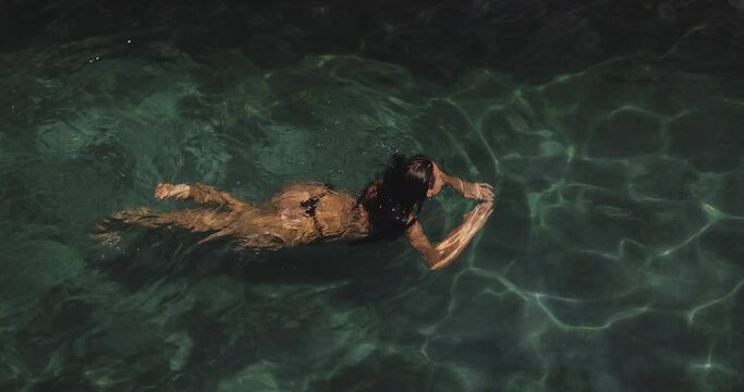Aerial View of Woman in Black Bikini Swimming in the Pool Outdoors
