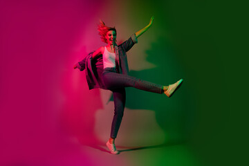 Full size photo of cheerful active lady youth dance on pop music raise legs isolated on gradient...