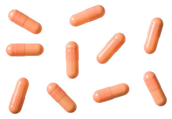 Orange capsules isolated on white background, top view.