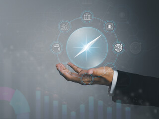 Business compass, businessman hand showing compass A guide to success in investment finance funds setting the direction for the future of business.
