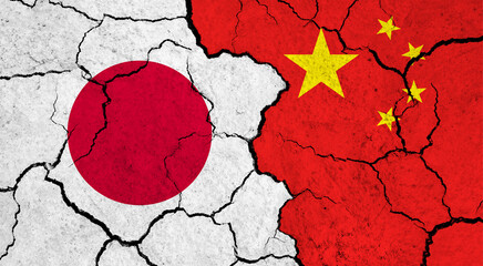 Flags of Japan and China on cracked surface - politics, relationship concept