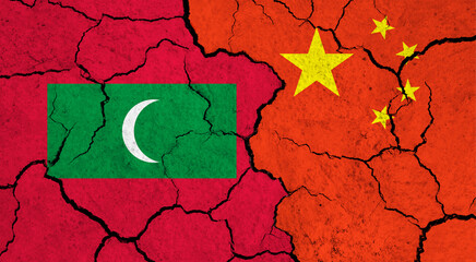 Flags of Maldives and China on cracked surface - politics, relationship concept
