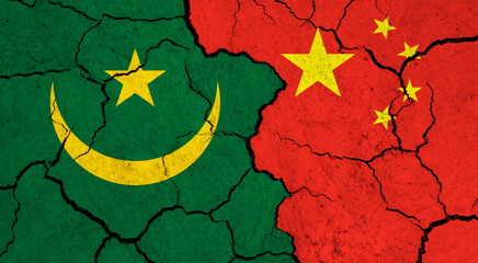 Flags of Mauretania and China on cracked surface - politics, relationship concept
