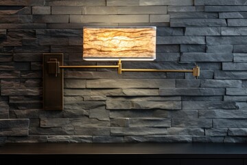 A contemporary, horizontal lamp used as an interior decoration on a modern grey stone wall.