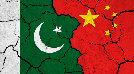Flags of Pakistan and China on cracked surface - politics, relationship concept