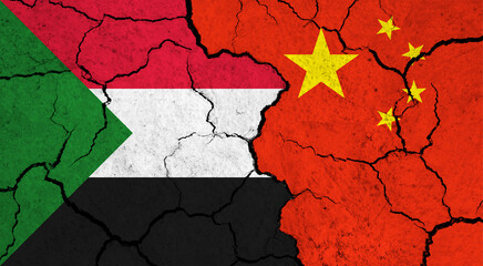 Flags of Sudan and China on cracked surface - politics, relationship concept